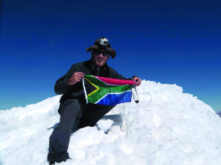 In this undated photo released on Monday Aug. 27, 2012 by the family of South African adventurer David du Plessis, 24, du Plessis holds up the flg of South Africa as he reaches the summit of Mount Mismi located in the Andes mountain range of Peru. David du Plessis, 24, was shot three times and robbed by two young men Saturday, Aug. 25, while seeking to follow the Amazon River from its origin to its mouth. He is now in stable condition at a Lima hospital. (AP Photo/David du Plessis family)