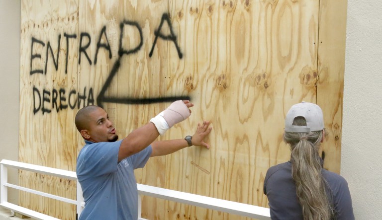 Employees of of the Courtyard Marriott Hotel board up windows as they prepare for the arrival if Hurricane Irma in San Juan, Puerto Rico, on Wednesday. Hurricane Irma is a Category 5 storm expected to hit Puerto Rico Wednesday and Florida later this week. (AP Photo/Danica Coto)
