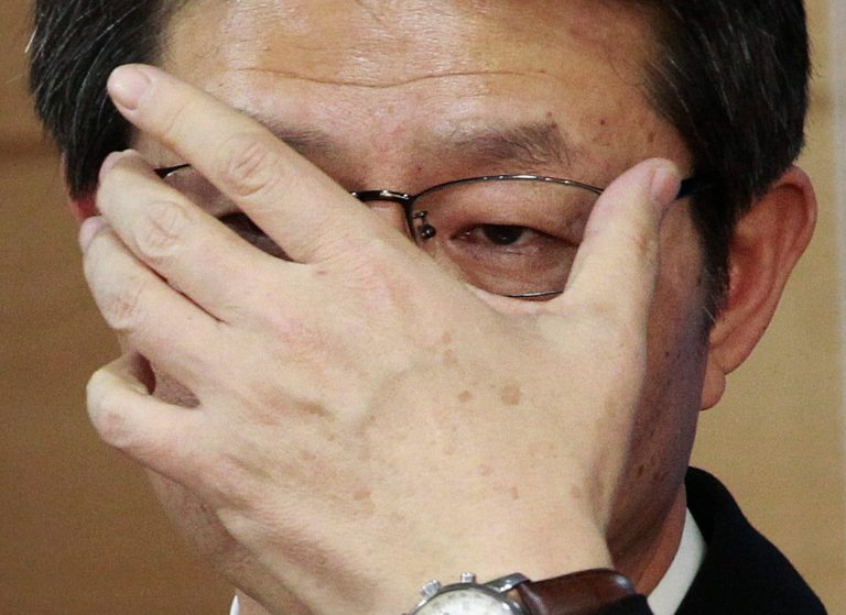 South Korean Unification Minister Ryoo Kihl-jae adjusts his glasses during a press conference at the government complex in Seoul, South Korea, Thursday, Feb. 6, 2014. While North Korea is threatening to cancel a reunion of Korean War-divided families later this month only one day after agreeing on dates for the emotional meetings, Ryoo said that the agreement must be followed. (AP Photo/Ahn Young-joon)