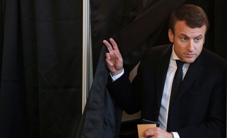 French independent centrist presidential candidate Emmanuel Macron leaves the polling booth as he prepares to cast his ballot in the presidential runoff election in Le Touquet, France, Sunday, May 7, 2017. (AP Photo/Christophe Ena, POOL)