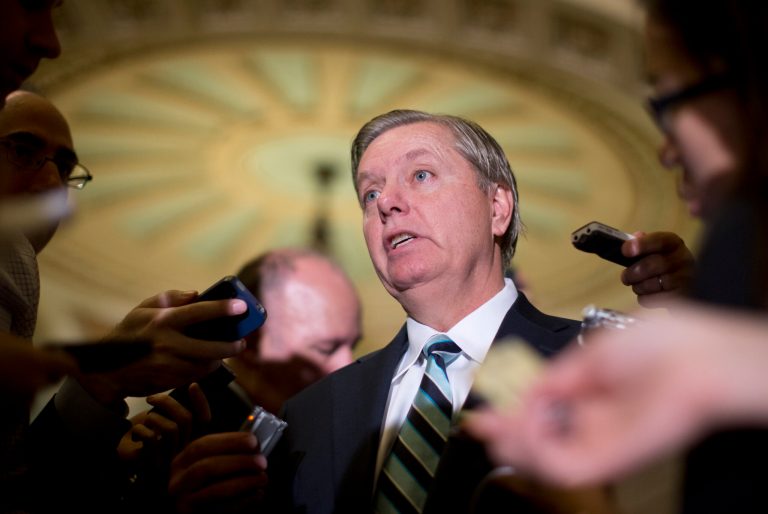 FILE - In this Oct. 16, 2013, file photo, Sen. Lindsey Graham, R-S.C., speaks with reporters on Capitol Hill in Washington. Graham threatened Monday, Oct. 28, to hold up all nominations for federal government positions until survivors of last year's deadly attack on the diplomatic post in Libya appear before Congress. (AP Photo/Carolyn Kaster, File)