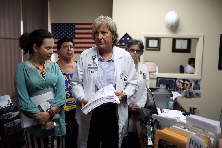 Martha Baker, a Registered Nurse, (R) delivers 13,000 petition signatures demanding healthcare expansion to the office of Florida State Rep. Jose Oliva, whose Hialeah district includes the highest number of Obamacare sign ups in the nation, as the Florida legislative body debates accepting Affordable Care Act funding on May 28, 2015 in Hialeah, Florida. (Photo by Joe Raedle/Getty Images)