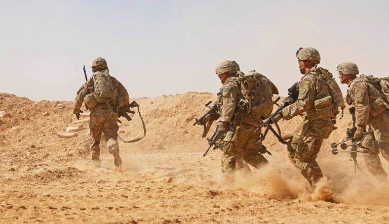 U.S. Soldiers assigned to the 3rd Cavalry Regiment and deployed in support of Combined Joint Task Force â Operation Inherent Resolve (CJTF-OIR) rush to a berm to establish a hasty fighting position during a live-fire training exercise near Al Asad Air Base (AAAB), Iraq, Sept. 26, 2018. AAAB is a CJTF-OIR enhanced partner capacity location dedicated to training partner forces and enhancing their effectiveness.