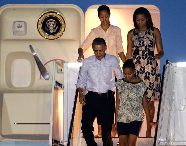   President Barack Obama arrives with first lady Michelle Obama, top, and daughters Malia, top left, and Sasha, bottom right, at Honolulu Joint Base Pearl Harbor-Hickam in Honolulu, for the start of their holiday vacation, Saturday, Dec. 22, 2012. (AP Photo/Gerald Herbert)  