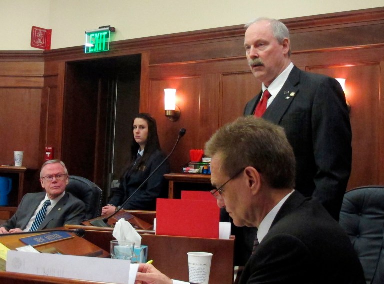 Sen. Bert Stedman, R-Sitka, top right, speaks on the floor of the Alaska Senate during discussion of proposed amendments to a bill aimed at advancing a major liquefied natural gas project on Tuesday, March 18, 2014, in Juneau, Alaska. Shown in the row in front of him is Sen. Dennis Egan. Seated beside him is Sen. Kevin Meyer. (AP Photo/Becky Bohrer)