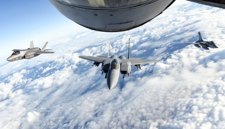 A Royal Air Force F-35 Lightning II, left, U.S. Air Force F-15E Strike Eagle, center, and French air force Dassault Rafale fly behind a U.S. Air Force KC-135 Stratotanker assigned to the 100th Air Refueling Wing during Exercise Point Blank over the English Channel, Nov. 27, 2018. Training with NATO allies like the U.K. and France improves interoperability and demonstrates the United Statesâ commitment to regional security. Exercise Point Blank also represents an opportunity to enhance interoperability and integration between allied fourth and fifth-generation fighter aircraft.