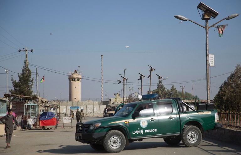 Afghan soldiers and police block the road to Bagram Airfield's main gate north of Kabul, Afghanistan, Saturday, Nov. 12, 2016. (AP Photos/Massoud Hossaini)