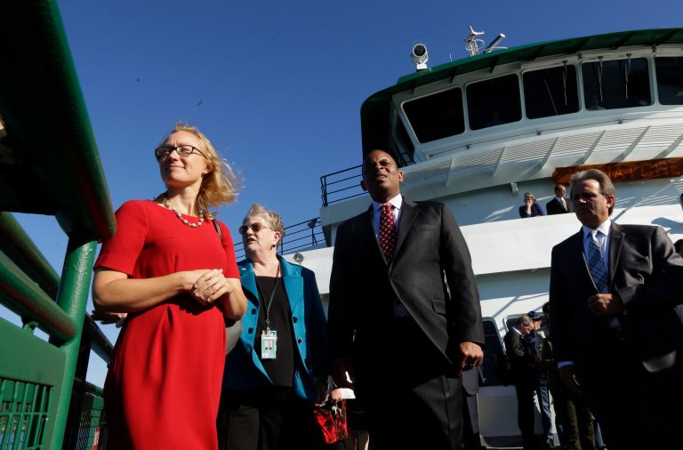 U.S. Department of Transportation Secretary Anthony Foxx, center, stands on the deck of a Washington state ferry with Lynn Peterson, left, Washington state Secretary of Transportation, and Lynne Griffith, second from left, assistant secretary for the Washington State Ferries Division, as they ride between Seattle and Bainbridge Island, Wash., Monday, Oct. 6, 2014. Foxx was in town at the invitation of U.S. Sen. Patty Murray, D-Wash., to learn more about Washington's ferry system and the need for both state and federal funding. (AP Photo/Ted S. Warren)