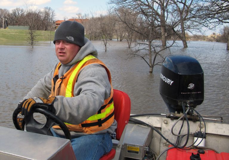 FILE - In this April 30, 2013 file photo, Mike Andersen of the US Geological Survey maneuvers a boat on the Red River in Fargo, N.D., so a USGA hydrologist can take stream flow measurements. Big money water projects used to be a favorite target of good-government types who railed against political pork. Now the same projects are a rare unifying factor in a dysfunctional Congress.  (AP Photo/Dave Kolpack, File)