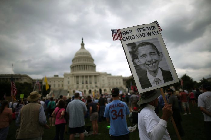 People attend a Tea Party rally in front of the U.S. Capitol. (Mark Wilson/Getty Images)
