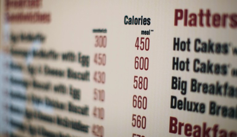 The rules, created by the Food and Drug Administration, mandate that the menu calories are posted on menu boards for people to see inside a restaurant. Retailers that oppose this say it's cumbersome and expensive to post information for food that is made to order, and there have been particular objections by those whose products are sold mostly through delivery. (AP Photo/Ed Ou, File)