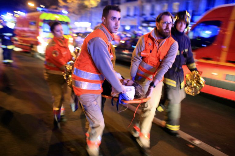 A woman is being evacuated from the Bataclan concert hall after a shooting in Paris. (AP Photo/Thibault Camus, File)