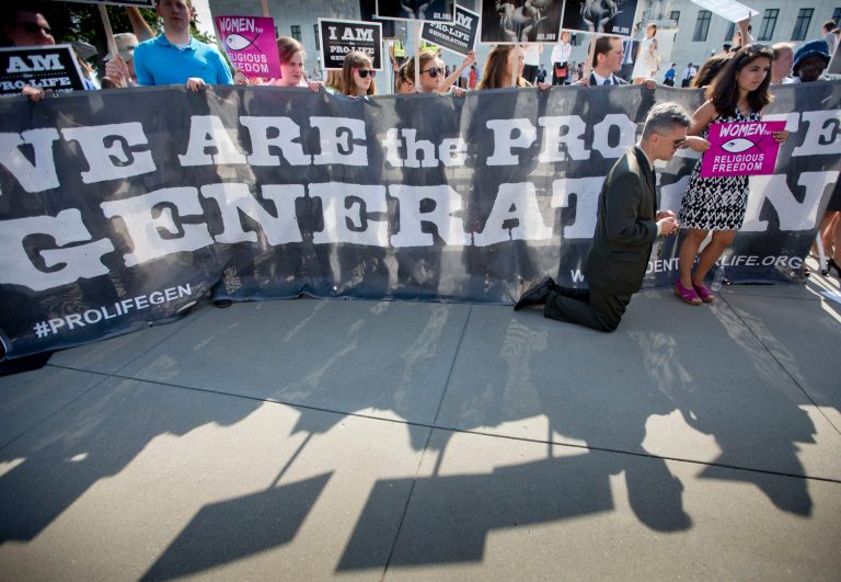 Michael Hichborn kneels and prays as he joins demonstrators while waiting for the Supreme Court's decision on the Hobby Lobby case outside the Supreme Court in Washington, Monday, June 30, 2014. The Supreme Court says corporations can hold religious objections that allow them to opt out of the new health law requirement that they cover contraceptives for women.(AP Photo/Pablo Martinez Monsivais)
