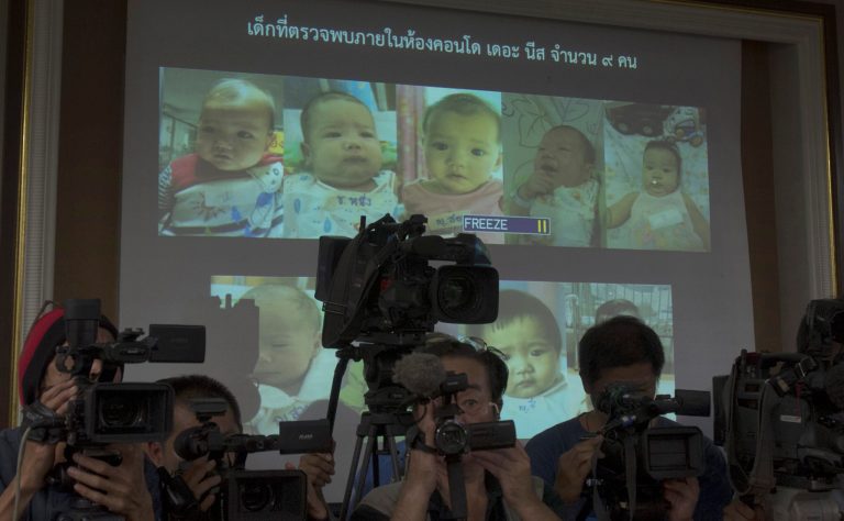 FILE - In this Tuesday, Aug. 12, 2014 file photo, Thai police display pictures of surrogate babies born to a Japanese man who is at the center of a surrogacy scandal during a press conference at the police headquarters in Chonburi, Thailand. A string of recent scandals has lifted a lid on Thailand's largely unregulated commercial surrogacy industry, which has been around for over a decade.  (AP Photo/Sakchai Lalit)
