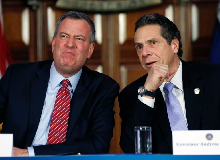 New York Gov. Andrew Cuomo, right, is opposed to letting individual municipalities set their own minimum wages and tax rates, as New York City Mayor Bill de Blasio wants to do. (AP Photo/Mike Groll)