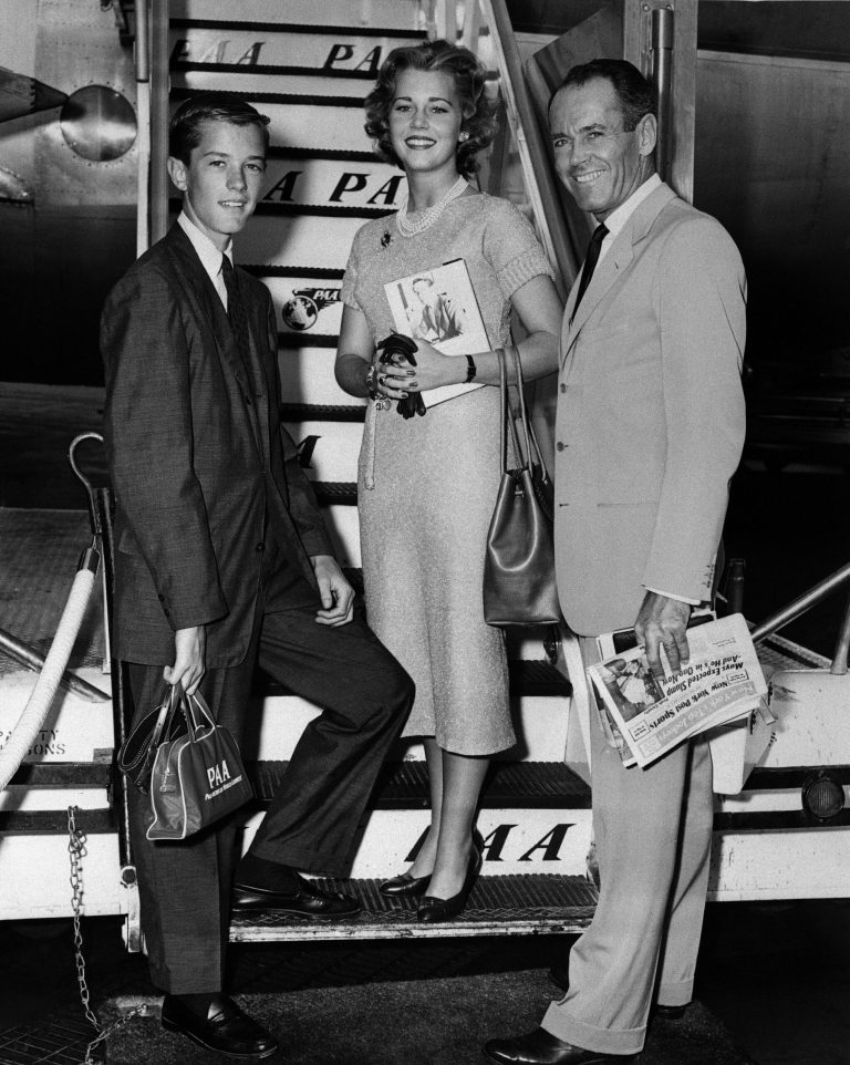 FILE - In this June 25, 1957 file photo, movie actor Henry Fonda, right, with his children, Jane and Peter, are shown at New York International Airport boarding a clipper airplane for Europe where they'll spend the summer seeing sights. On on Saturday, April 27, 2013, Jane Fonda, the 75-year-old Oscar winner , will place her hand and footprints next to her father's in the concrete shrine to celebrity outside Hollywood's TCL Chinese Theatre. Then she'll present a special screening of the film she made with her dad, 