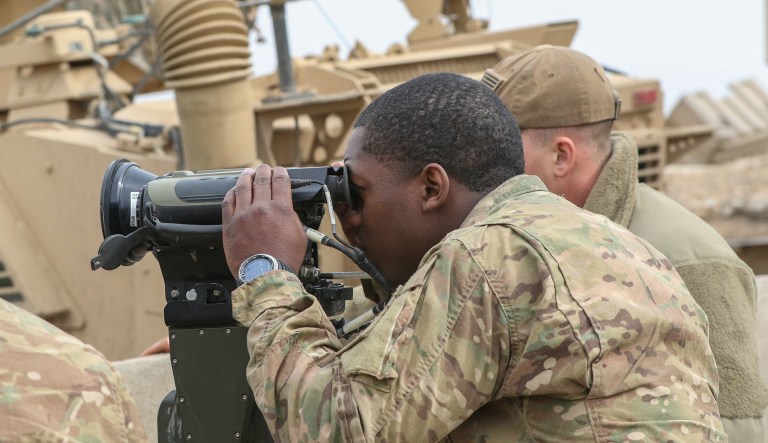 U.S. troops observe a target being struck by coalition artillery in Iraq during the offensive to liberate West Mosul from ISIS. U.S. troops are already serving in a quasi-peacekeeping role, patrolling areas in Syria where rival factions might otherwise be fighting among themselves. (U.S. Army photo by Staff Sgt. Jason Hull)