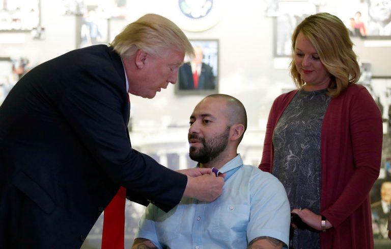 During the short ceremony, the president placed the Purple Heart on the lapel of Sgt. First Class Alvaro Barrientos. (AP Photo/Alex Brandon)