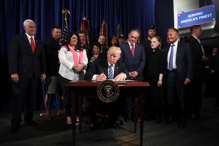 President Donald Trump signs an Executive Order on 