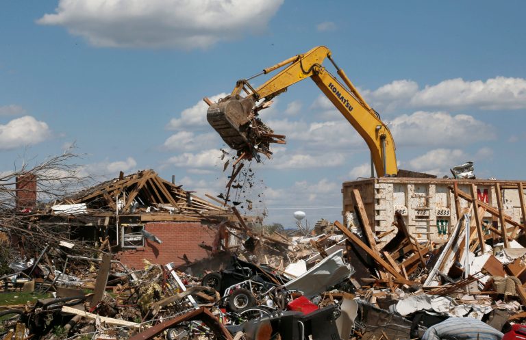   FILE - In this Friday, June 7, 2013 file photo, heavy equipment removes debris from a home destroyed by the May 20, 2013 tornado in the Plaza Towers neighborhood of Moore, Okla. In 2013, in the nation's heartland, tornadoes are flirting with a record for the fewest, with just a bit more than half the normal number of nearly 1,300 twisters reported by mid-September. A shift in the jet stream is credited. (AP Photo/Sue Ogrocki)  