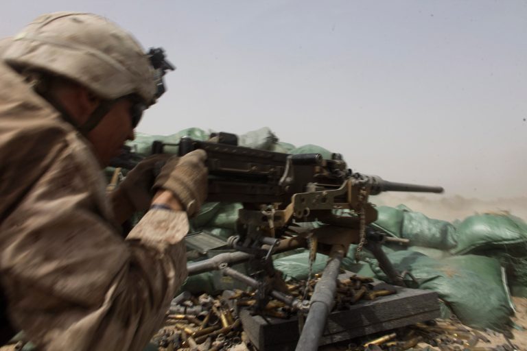 A U.S. Marine fires a heavy machine gun to counter Taliban fire from a nearby treeline during a firefight in Helmand province, southern Afghanistan, Aug. 25, 2011.ÃÂ A new Gallup poll shows that for the first time since the U.S. sent troops into Afghanistan in 2001, more Americans agree the intervention was a mistake than disagree.ÃÂ (AP Photo/Brennan Linsley)