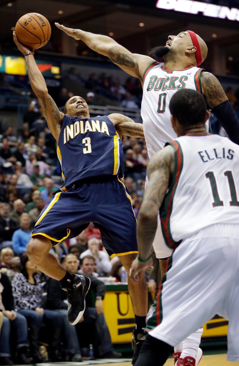   Indiana Pacers' George Hill (3) shoots with Milwaukee Bucks' Drew Gooden (0) and Monta Ellis (11) defending during the second half of an NBA basketball game Tuesday, Dec. 18, 2012, in Milwaukee. The Bucks won 98-93. (AP Photo/Morry Gash)  
