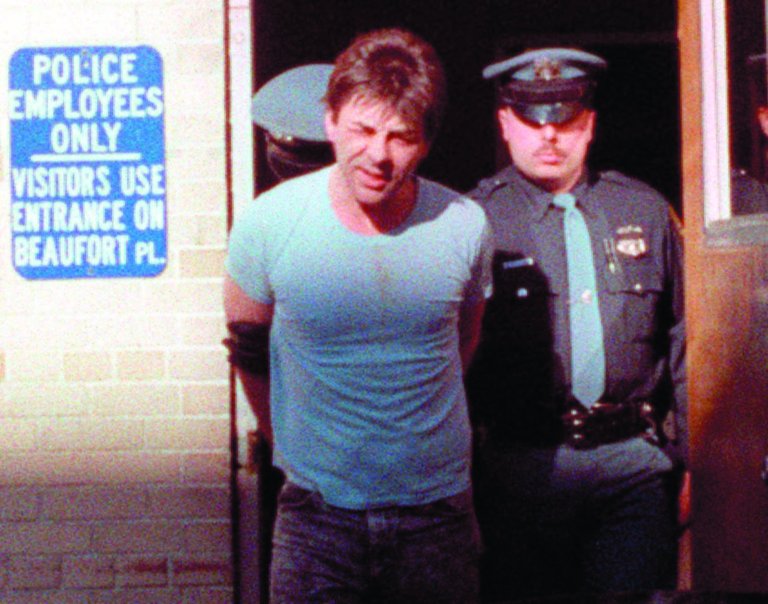 FILE - In this May 24, 1990 file photo, Robert Kosilek is led to the county jail following his arraignment on drunken driving charges, in New Rochelle, N.Y. Kosilek was convicted in the 1990 murder of his wife in Massachusetts, and has been living as a woman, Michelle Kosilek, and receiving hormone treatments while serving life in prison in Massachusetts. On Tuesday, Sept. 4, 2012, U.S. District Judge Mark Wolf ordered Massachusetts to provide a taxpayer-funded sex-change operation for Kosilek. (AP Photo/Frankie Ziths, File)