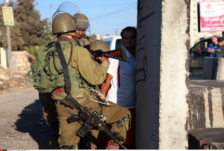 Israeli soldiers detain a Palestinian during clashes at a protest against the Jewish settlement of Ofra, in the West Bank village of Silwad, near Ramallah. (Sipa via AP Images)