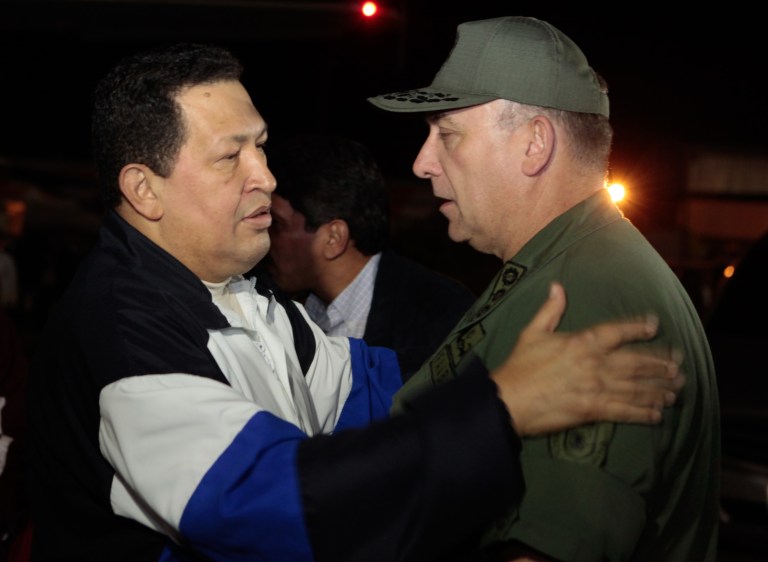   In this photo released by Miraflores Press Office, Venezuela's President Hugo Chavez, left, speaks with his Defense Minister Diego Molero upon his arrival to Simon Bolivar airport in Maiquetia, near Caracas. Venezuela, Friday, Dec. 7, 2012. Chavez arrived back home in Caracas after 10 days of medical treatment in Cuba. (AP Photo/Miraflores Press Office, Marcelo Garcia)  