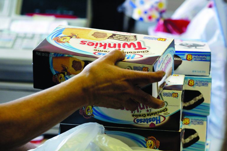 A cashier rings up boxes of Hostess Twinkies and Cup Cakes at the Hostess Brands' bakery in Denver, Friday Nov. 16, 2012. Hostess Brands Inc. said Friday it would shutter after years of struggling with management turmoil, rising labor costs and the ever-changing tastes of Americans even as its pantry of sugary cakes seemed suspended in time. (AP Photo/Brennan Linsley)