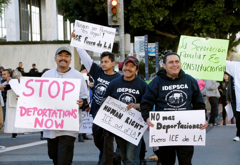 Immigration activists march in a rally against the U.S. Immigration and Customs Enforcement's (ICE) raids and deportation of immigrants, on Tuesday, Jan. 26, 2016, near the downtown Los Angeles Federal Building. Organizers said in a news release they would be demanding a stop to deportation of Central American immigrant families and recognition that they are refugees seeking asylum. (AP Photo/Nick Ut)