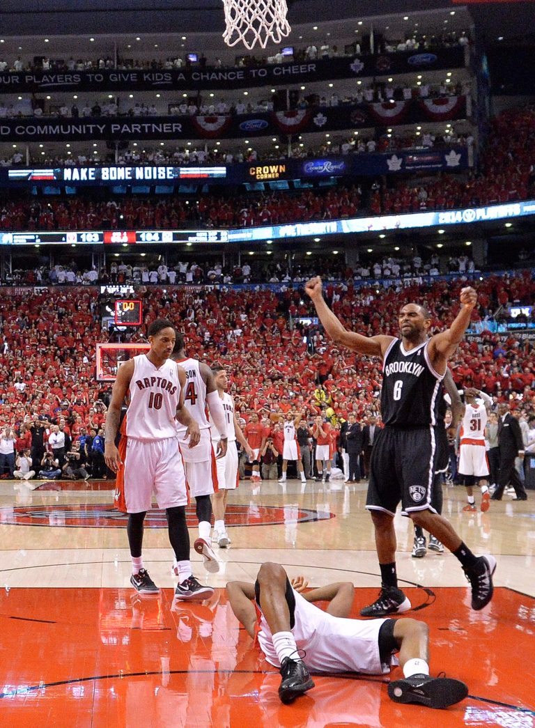 Brooklyn Nets forward Alan Anderson (6) celebrates as Toronto Raptors guard Kyle Lowry, front center, lays on the ground after missing the basket following second half NBA game seven playoff basketball action in Toronto on Sunday, May 4, 2014.The Nets defeated the Raptors to advance to the next round. (AP Photo/The Canadian Press, Nathan Denette)