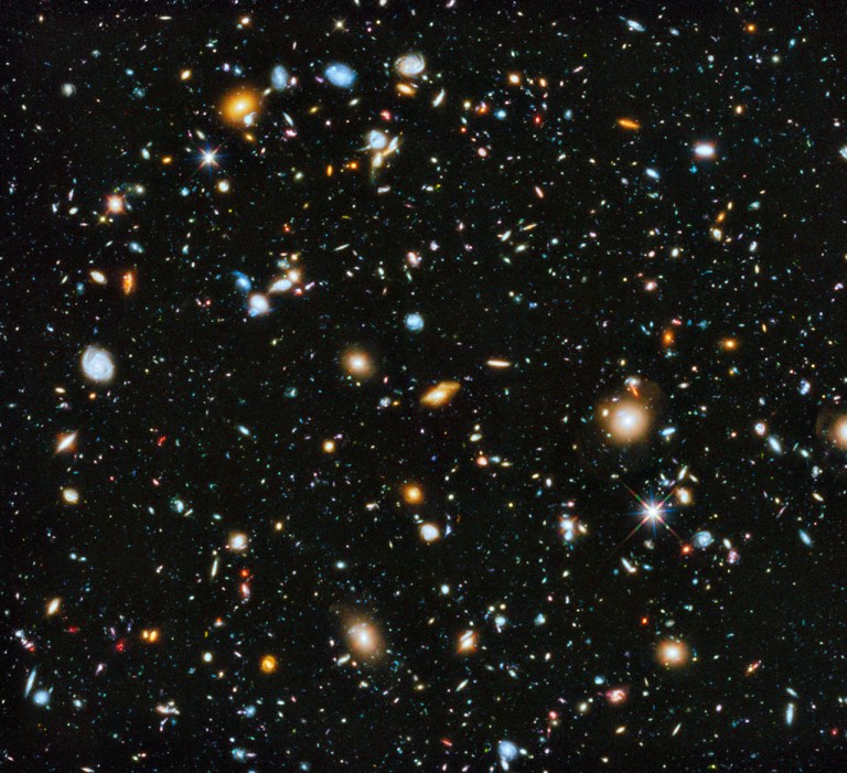 This handout composite image provided by NASA shows the visible and near infrared light spectrum collected from NASA's Hubble Space Telescope over a nine-year period. The Hubble Space Telescope has captured our cosmos at its most colorful. A new NASA panorama looking deep and far into the universe for the first time includes ultraviolet light, which is normally not visible to the human eye. It shows up in the photo as bright baby blue with spinning galaxies, which are about 5 to 10 billion years old, not too old or young in cosmic terms. The photo was taken over 841 orbits of the telescope and shows about 10,000 multi-colored galaxies. (AP Photo/NASA)