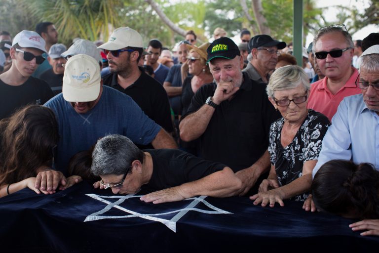 Relatives of four-year-old Israeli boy Daniel Tragerman cries over his coffin during his funeral in a cemetery located next to the Israeli community of Yevul, near the Israeli Gaza border, Sunday, Aug. 24, 2014. Tragerman was killed when a mortar shell hit two cars in the parking lot of Nahal Oz, a small farming community near Gaza. (AP Photo/Oren Ziv)