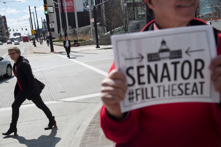 The split decision means the lower court's ruling in a banking case stands. (AP Photo/John Minchillo)