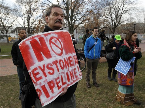 Protestors gather in Lafayette Park, across the street from the White House in Washington, Wednesday, Feb. 13, 2013, before prominent environmental leaders tied themselves to the White House gate to protest the Keystone XL oil pipeline. (AP Photo/Ann Heisenfelt)