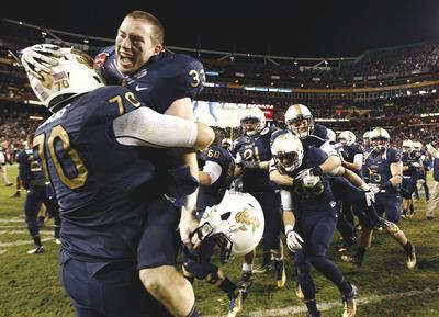 Evan Vucci/AP
Graham Vickers(70)and John Howell(33)helped Navy win the closest contest of its 10-game winning streak over Army.