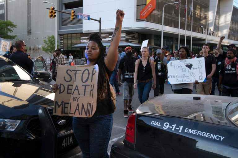 Demonstrators march during a protest against the acquittal of Michael Brelo, a patrolman charged in the shooting deaths of two unarmed suspects, Saturday, May 23, 2015, in Cleveland. Brelo was acquitted Saturday in a case involving a 137-shot barrage of gunfire that helped prompt the U.S. Department of Justice determine the city police department had a history of using excessive force and violating civil rights. (AP Photo/John Minchillo)