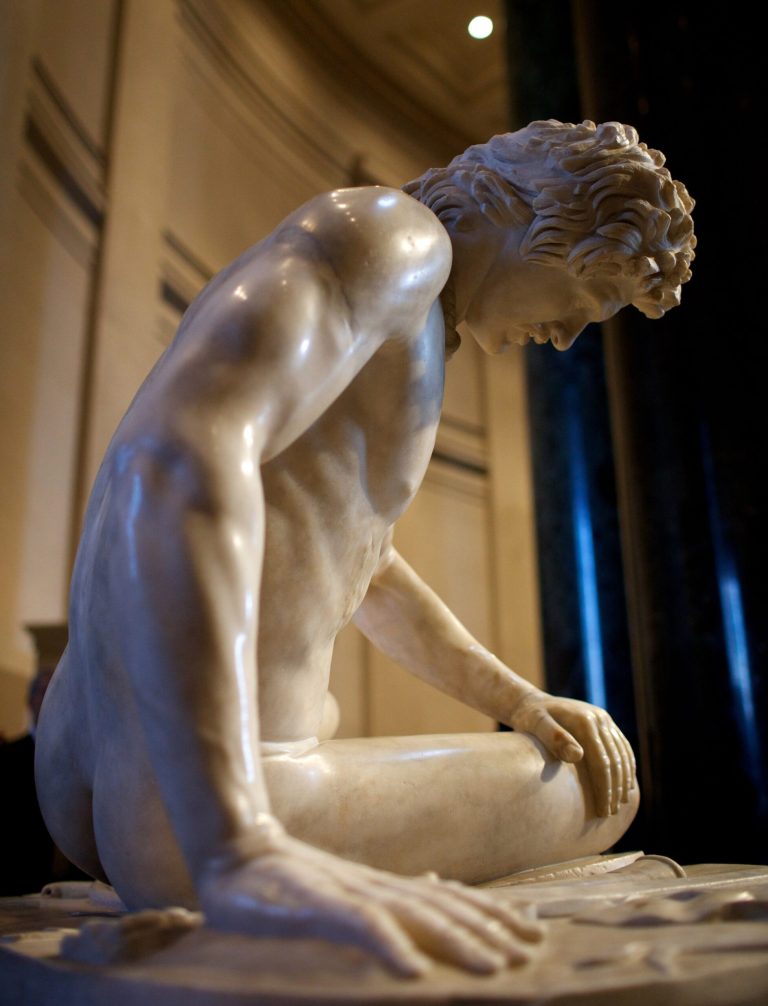 The Dying Gaul, an ancient Roman sculpture created during the first or second century AD, is unveiled at the National Gallery of Art in Washington, Thursday, Dec. 12, 2013.  The Dying Gaul is traveling outside of Italy for the first time in more than two centuries.  (AP Photo/Molly Riley)