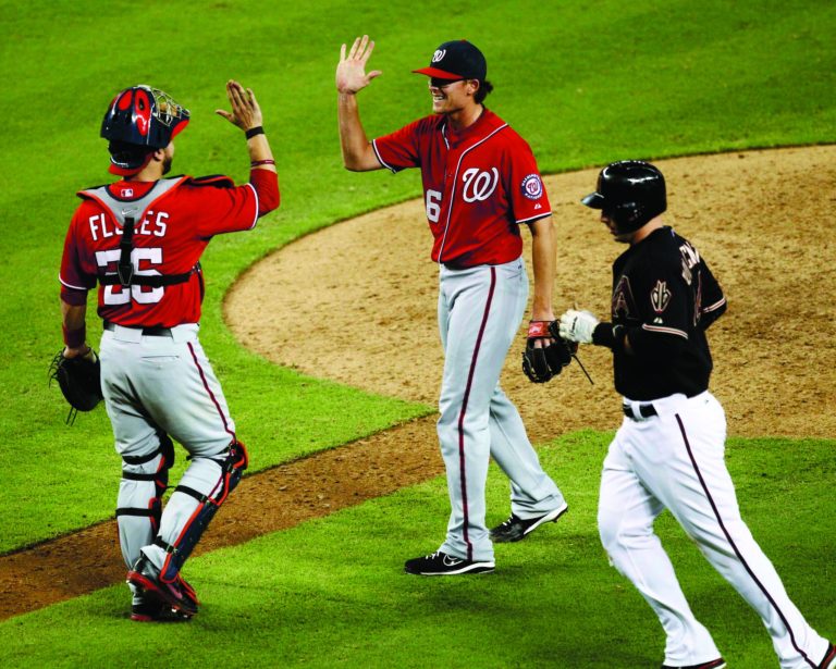Matt York/AP
Jesus Flores threw out just his fifth runner in 50 attempts this season and drove in the winning run as the Nationals won their eighth straight game Saturday night.