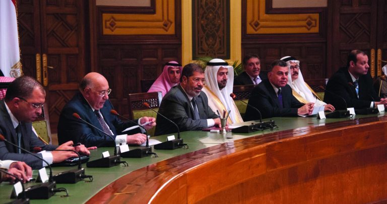 This image released by the Egyptian Presidency shows President Mohammed Morsi, center, meeting with Saudi businessmen in Cairo, Egypt, Tuesday, Sept. 11, 2012. (AP Photo/Egyptian Presidency)