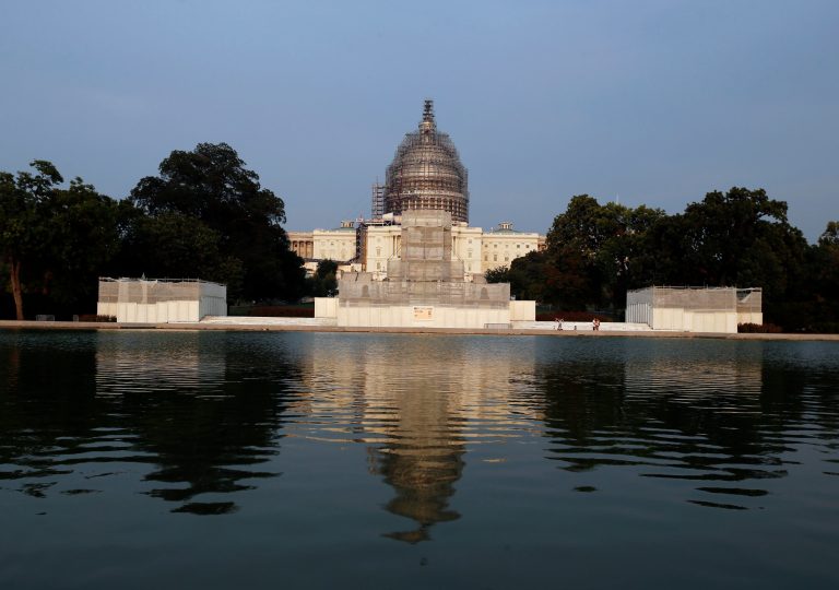The west front of the U.S. Capitol is seen under repair and in the reflecting pool, Wednesday, Sept. 2, 2015 in Washington. (AP Photo/Alex Brandon)