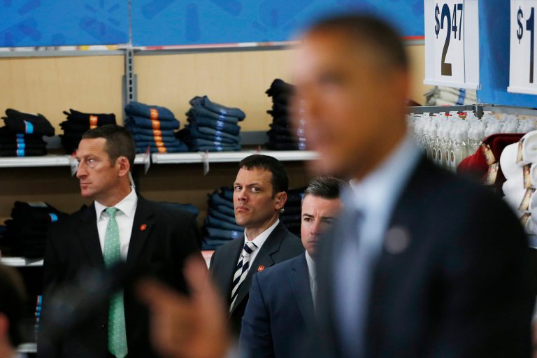 Members of the Secret Service watch as Obama speaks at a Walmart store on May 9. (Getty images/Stephen Lam)