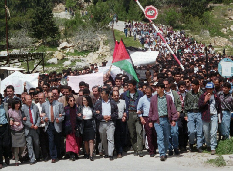 FILE - In this April 1, 1996 file photo, Palestinian protesters march from the Bir Zeit University in the West Bank. The expulsion of an Israeli journalist on Sept. 23, 2014, from an academic conference hosted by a top Palestinian university has unleashed a fierce debate about academic freedom in the West Bank and is shining a spotlight on the apparent radicalization of some young Palestinians who are disillusioned by years of failed peace efforts and have grown up with little contact with Israelis. (AP Photo/Sanad Sahlieh, File)