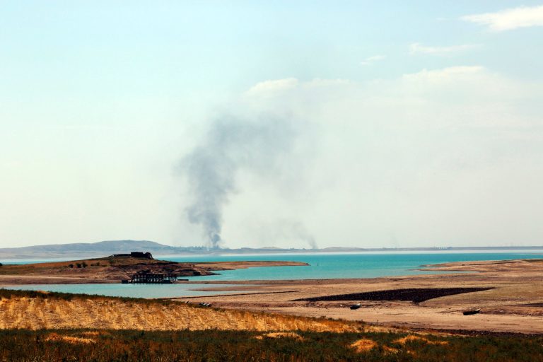 Smoke rises during airstrikes targeting Islamic State militants at the Mosul Dam outside Mosul, Iraq, Monday. (AP Photo/Khalid Mohammed)