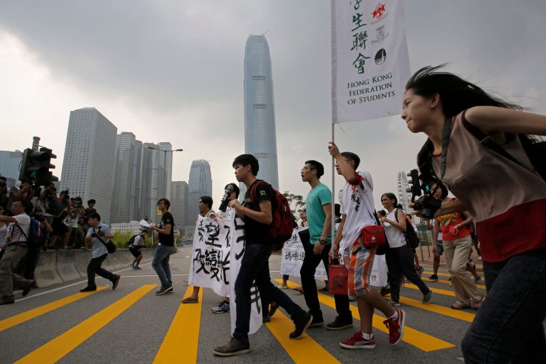 Students march in front of the financial Central district during a protest on the third day of a week-long boycott of classes in Hong Kong, Wednesday, Sept. 24, 2014. Thousands of Hong Kong college and university students boycotted classes to protest Beijing's decision to restrict voting reforms, the start of a weeklong strike that marks the latest phase in the battle for democracy in the southern Chinese city. (AP Photo/Vincent Yu)