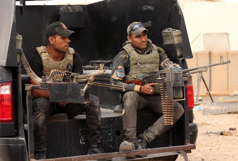 Iraqi anti-terrorism soldiers guard a graduation ceremony of Sunni tribal volunteers joining Iraqi security forces in the town of Amiriyat al-Fallujah, west of Baghdad, Iraq, Friday, May 8, 2015. (AP Photo/Hadi Mizban)