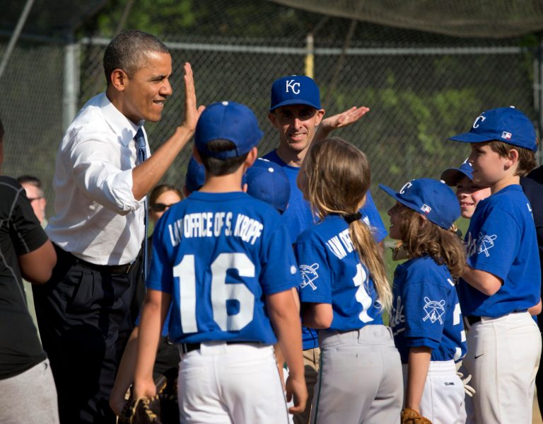 In this May 19, 2014, photo, President Barack Obama greets players as he makes an unannounced stop to surprise members of the Northwest little league baseball teams at Friendship Park in Washington.  Obama seems to have caught a bad case of cabin fever. Since taking office, Obama has periodically grumbled about the claustrophobia that sets in when his every move is surrounded by intense security, rendering it nearly impossible to enjoy the simple pleasures that private citizens take for granted. But in recent days, the president has made more of a point to get out.  (AP Photo/Pablo Martinez Monsivais)