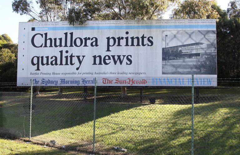   A billboard advertising Fairfax Printing House and the town of Chullora stands outside Fairfax Printers in the outer suburb of Chullora in Sydney, Australia, Monday, June 18, 2012. Australian publisher Fairfax Media Ltd. said Monday it will shed 1,900 jobs over three years and erect pay walls for two flagship newspapers as readers increasingly move online. Australia's largest newspaper publisher after News Corp. also said it would close the printing plant in Sydney as well as plants in Melbourne by June 2014. (AP Photo/Rob Griffith)  