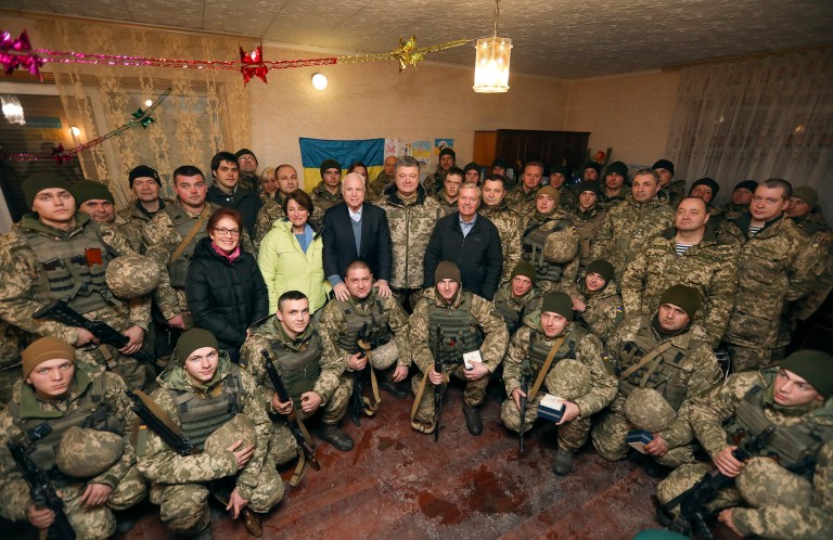 Sen. John McCain, center left, poses with Ukrainian President Petro Poroshenko center, Sen. Lindsey Graham, center right, and Sen. Amy Klobuchar for a photo with the Ukrainian marines in December 2016. 